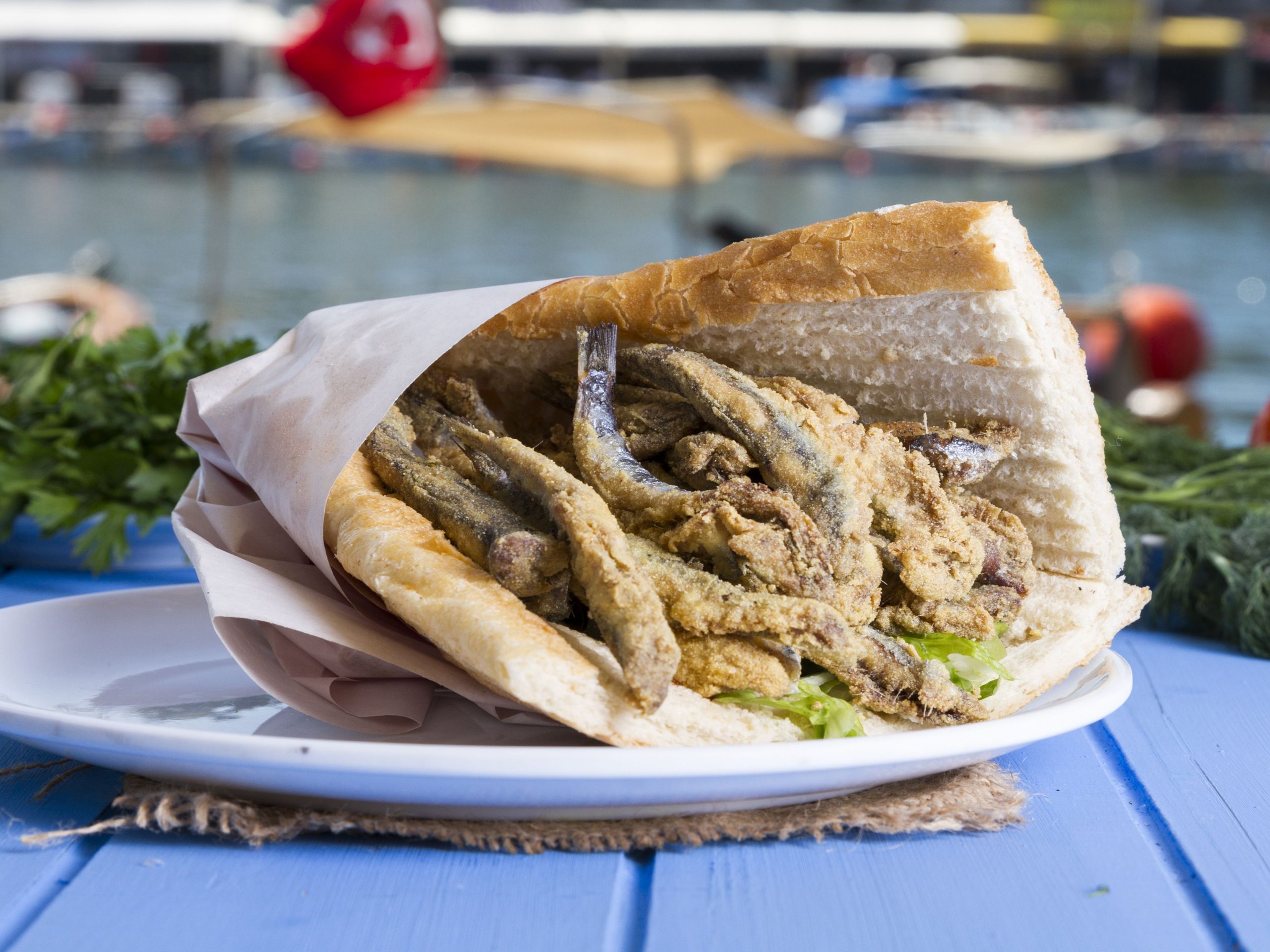 Balık ekmek grilled mackerel sandwich with onions and lettuce by the Galata Bridge in Istanbul
