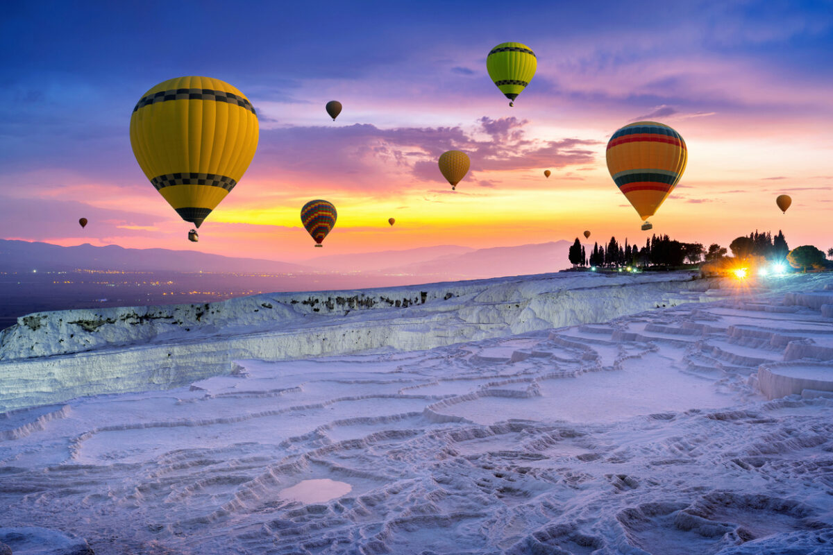 Hot Air Balloon Ride over Pamukkale White Terraces at Sunrise Hot air balloon flying over Pamukkale white travertine terraces at sunrise Turkey