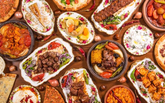 Top 20 famous Turkish foods – a traditional kahvaltı breakfast spread with cheese, olives, eggs, simit, and tulip tea glasses
