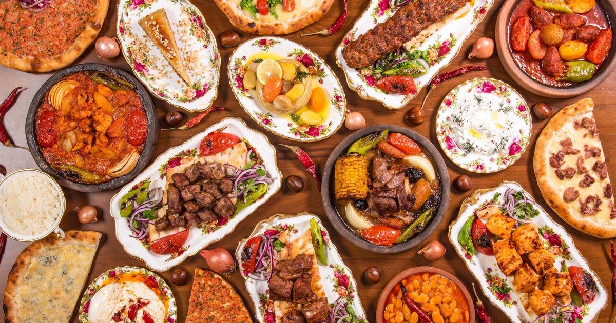 Top 20 famous Turkish foods – a traditional kahvaltı breakfast spread with cheese, olives, eggs, simit, and tulip tea glasses