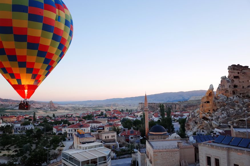 Cave hotel rooftop in Göreme overlooking balloons during this Cappadocia 3 day itinerary