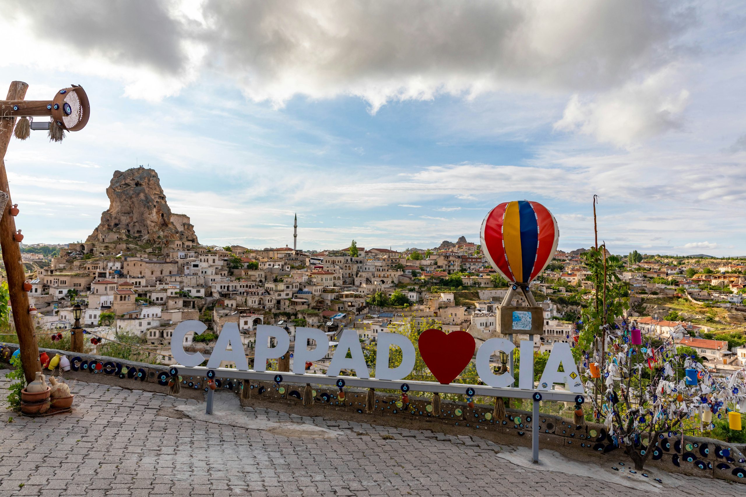 Cappadocia hot air balloons rising over fairy chimneys at sunrise in golden morning light