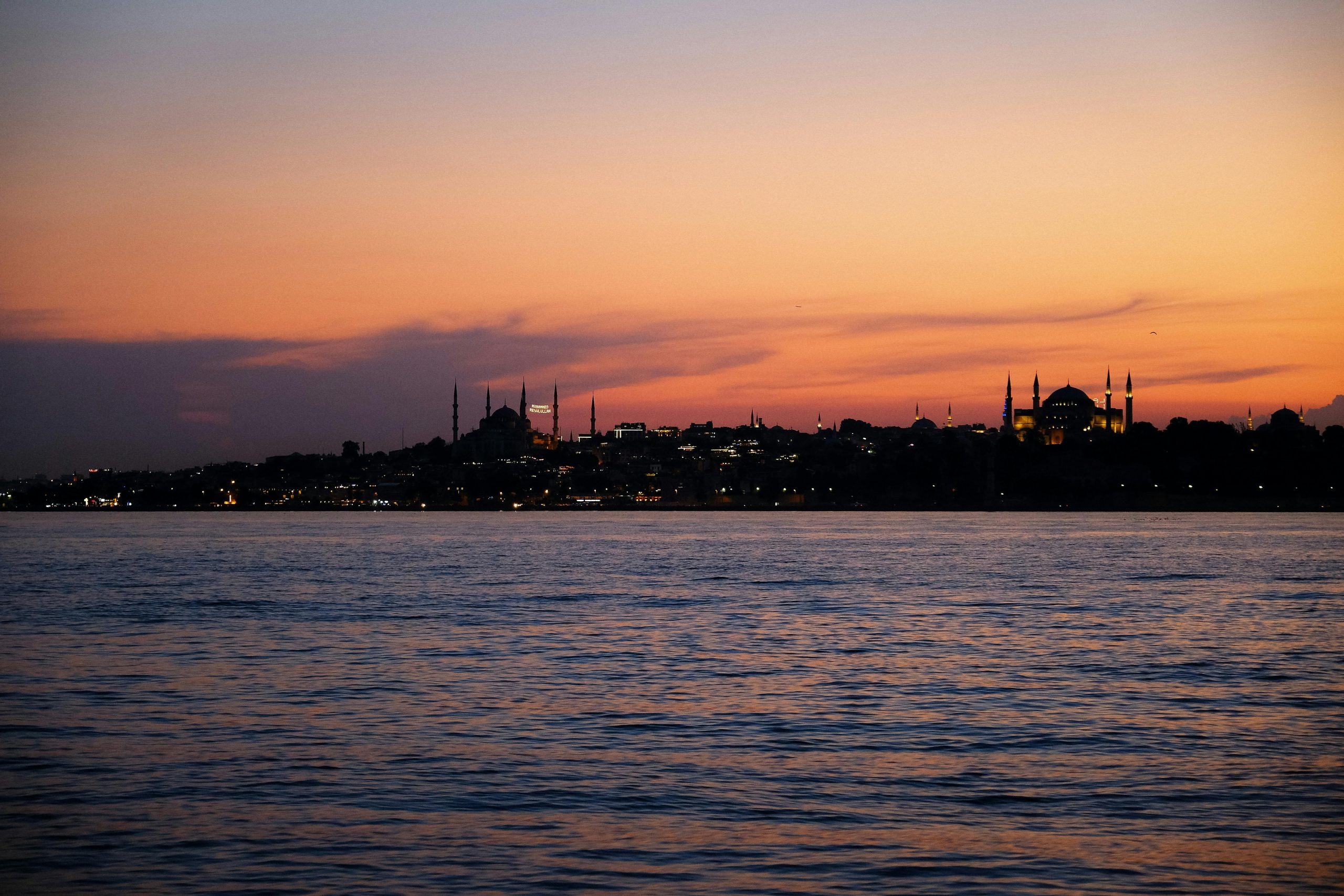 Istanbul 3 day itinerary featured view of Hagia Sophia and Blue Mosque skyline at sunset over the Bosphorus